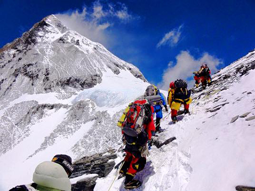 [Photo of climbers climbing Mt. Everest]
