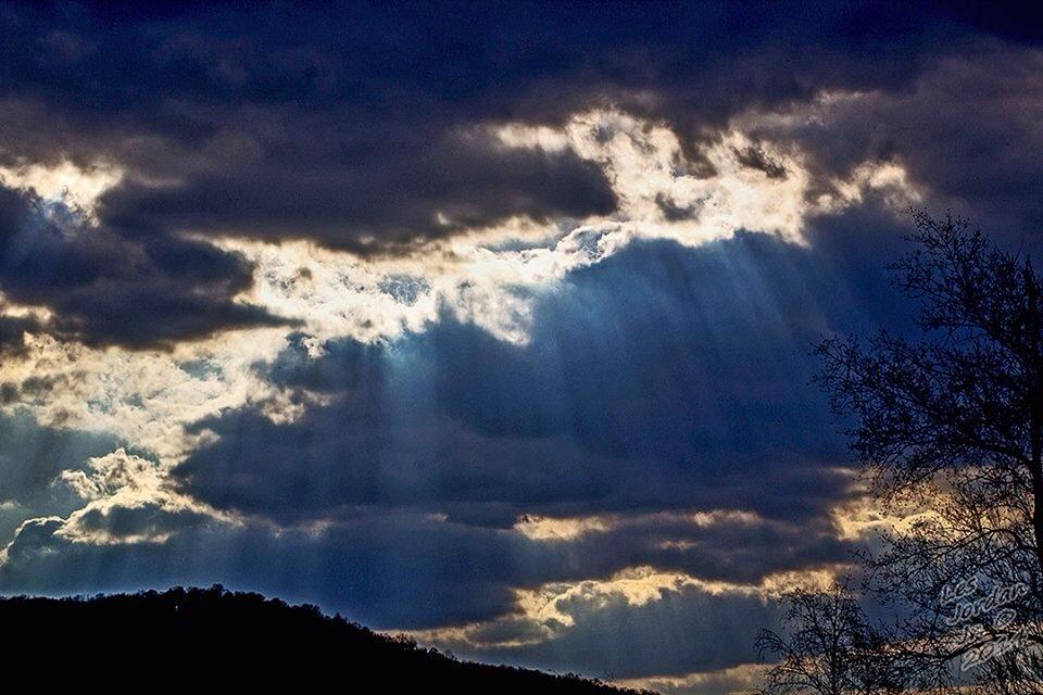 [Photo of sunlight shining through the clouds]