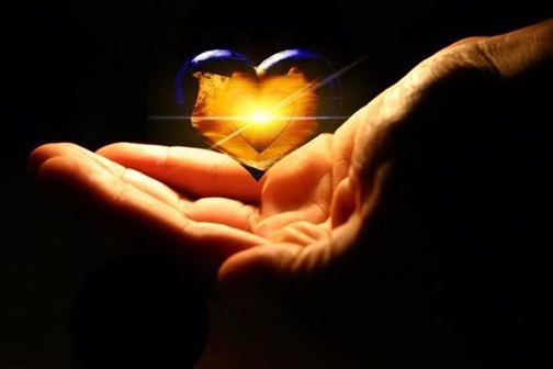 Photo of glowing heart in a hand