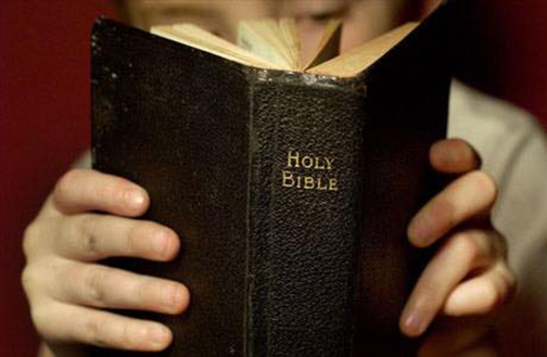 [Photo of person reading the Bible]